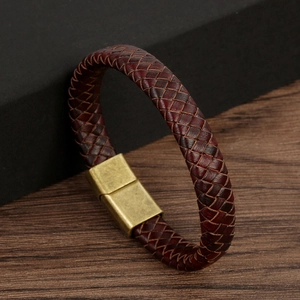 Close-up of red-brown braided leather bracelet with bronze magnetic metal clasp