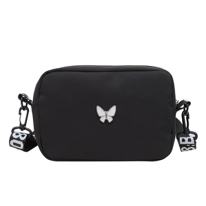 Minimalist black nylon crossbody bag with metal butterfly and patterned wide strap