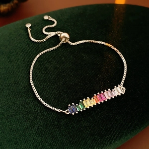 Detail of adjustable silver bracelet with colorful rainbow baguette zircon stones