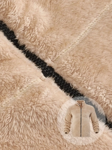 Detail of premium fleece jacket showing fine stitching and smooth metal zipper texture