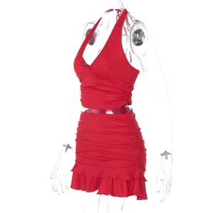Detail view of red halter top and mini skirt set with ruched texture and ruffle hem