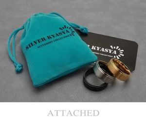 Three matte brushed wedding rings in black, silver, and gold with blue velvet pouch