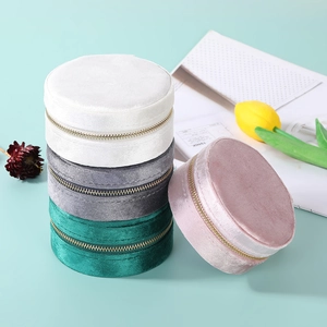 Portable round velvet jewelry travel cases in multiple colors with secure zipper closure