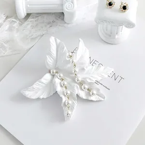 White leaf-shaped resin jewelry display stand with natural leaf texture and elegant design