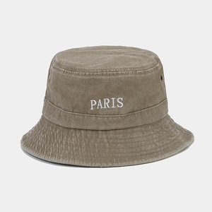 Detail of PARIS embroidery on washed khaki cotton bucket hat with metal eyelets