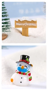 Detail of Christmas snowman figurine with mask and Merry Christmas tree stump sign