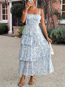 Detail view of tiered skirt layers on a floral summer dress with blue porcelain patterns