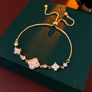 Macro view of gold-plated clover bracelet featuring zircon pavé inlay and pull-style clasp