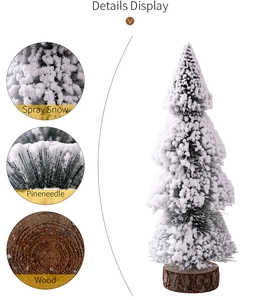 Detail display of mini cedar Christmas tree with snowy pine needles and a wooden base