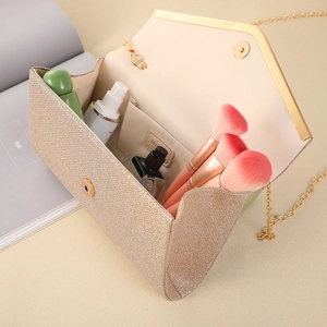 Gold glitter envelope clutch bag with chain strap and interior makeup storage view