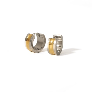 Close-up of two-tone gold and silver stainless steel hoop earrings with brushed finish