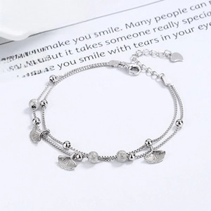 Detailed macro of S925 sterling silver double-layer bracelet with ginkgo leaf charms