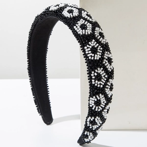 Fashionable wide beaded headband featuring monochrome black and white geometric pattern