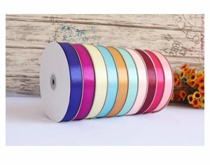 Close-up of assorted colorful 2cm satin ribbon rolls for gift wrapping and cake decoration