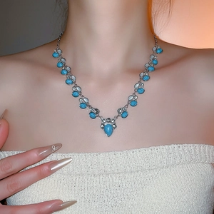 Detail showing vintage bohemian style turquoise teardrop necklace on collarbone