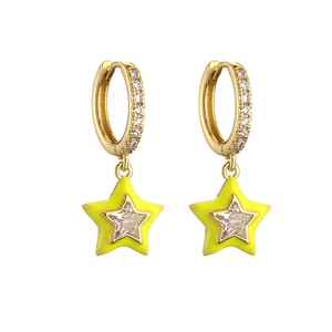 Detail of neon yellow star earrings with gold plating and sparkling zircon stones