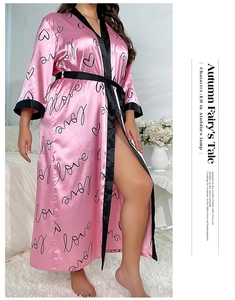 Detail of pink silk satin long robe with black love lettering print and waist belt