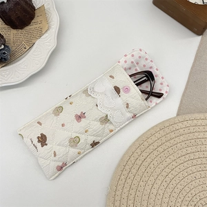 Detailed close-up of quilted cotton bear glasses pouch with heart lace and snap button