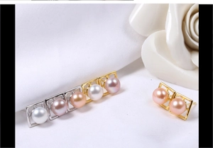 Detailed view of geometric square pearl earrings in various colors on white fabric