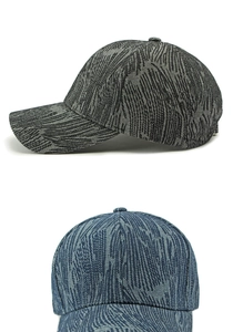 Detail of dark grey and denim blue baseball caps with unique jacquard texture and curved brim