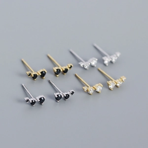 Detail showing four pairs of geometric S925 silver stud earrings with zirconia inlays