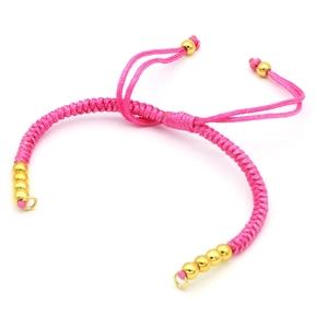 Handmade adjustable pink braided rope bracelet with decorative gold round beads on white background