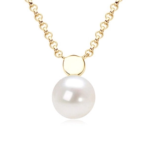 Macro detail of natural freshwater pearl pendant on a gold chain necklace for women