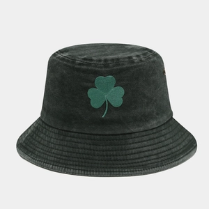 Detailed view of green clover embroidery on vintage washed denim fisherman bucket hat
