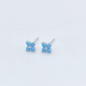 Macro shot of S925 sterling silver four-leaf flower stud earrings with blue turquoise gems