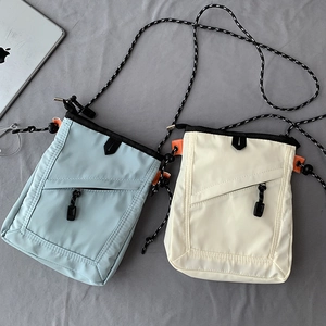 Detailed top view of nylon crossbody bags in blue and white with braided rope straps