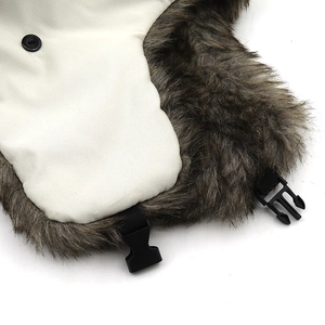 Close-up of windproof trapper hat with cream fabric and brown faux fur lining detail