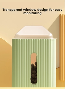 Detail of mint green pet feeder with vertical wave texture and transparent food window
