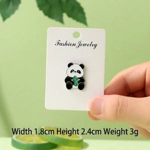 Detailed view of enamel panda brooch with green bamboo leaf and 1.8cm x 2.4cm dimensions