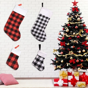 Red and black buffalo plaid Christmas stockings set hanging by a tree for home decoration