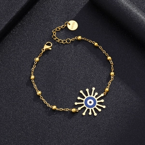 Detail view of gold stainless steel bracelet with blue evil eye sun pendant and lobster clasp