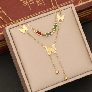 Gold double-layer butterfly necklace with colorful stones and beads on jewelry box