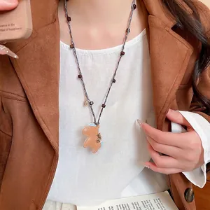 Bohemian acrylic stone beaded necklace featuring a brown leather horse charm and woven cord