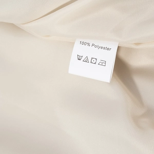 Detailed macro view of the 100% polyester fabric lining and care label for the jacket set