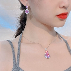 Detail of pink zircon jewelry set with necklace and earrings on female model