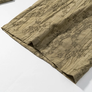 Detailed macro view of moss green jacquard fabric texture and hem stitching on casual set