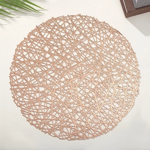 Close-up of rose gold hollow mesh placemat with a minimalist round woven design