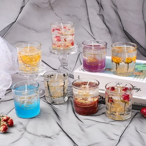 Handmade scented jelly candles in glass with gold foil and dried flowers for decor