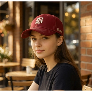 Close-up of vintage 3D embroidered B logo on high-quality burgundy cotton baseball cap