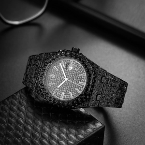 Macro shot of iced out black diamond watch on leather cushion with calendar detail