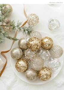 Flat lay of 6cm gold and champagne Christmas baubles with Merry Christmas lettering