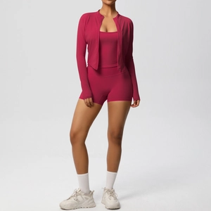 Detailed view of rose red three-piece yoga set with zip jacket, sports bra and gym shorts