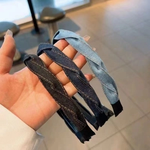 Three twisted denim headbands in blue shades with golden stitching for a vintage style