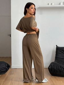 Side view of brown lounge set showing the loose fit and drape of the wide-leg trousers