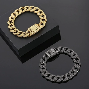 Macro view of heavy cuban link bracelets with textured grain finish and large square clasp