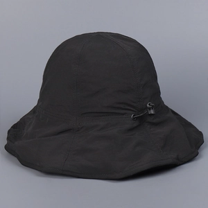 Detail of black sun hat featuring adjustable elastic drawstring and plastic toggle buckle
